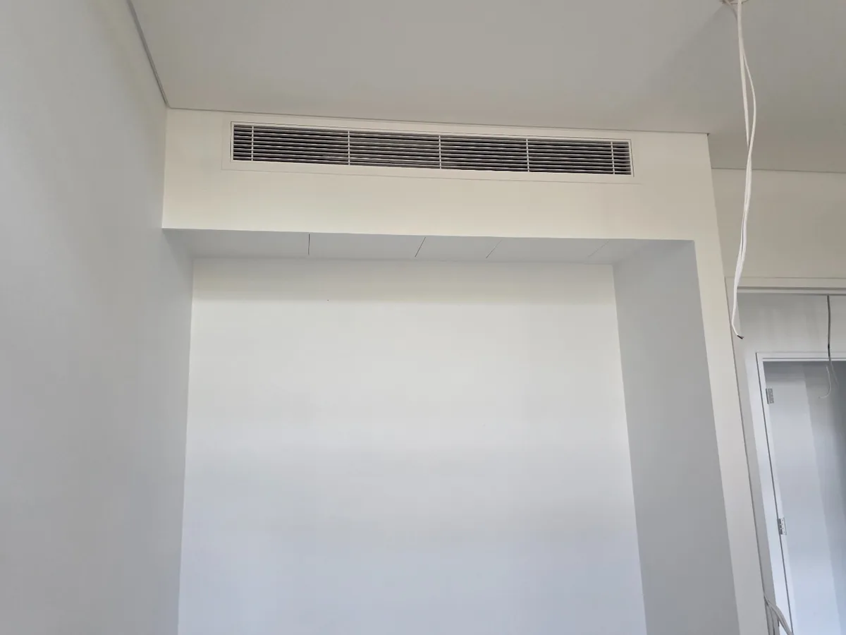 Installed linear grille in apartment bulkhead